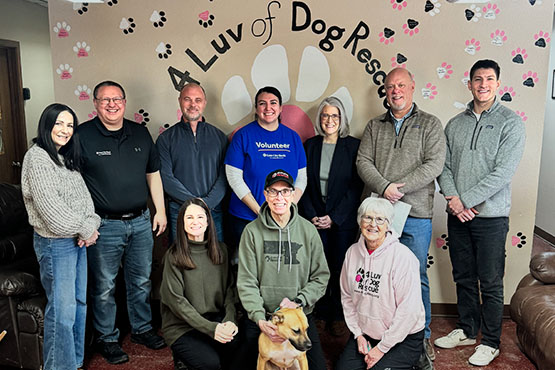 Gate City Bank employees give a donation to 4 Luv of Dog Rescue through the bank’s charity gift program for homebuyers